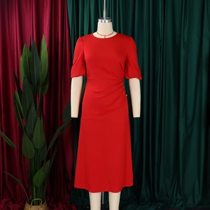 Detail of red crew neck dress with pleated waist and metallic button accents