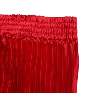 Detail of the elastic waistband and pleated satin fabric texture on this red skirt