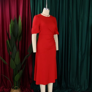 Detail of red short sleeve midi dress with ruched waist design on a mannequin