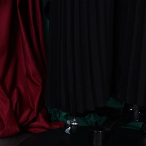 Detailed view of black pleated fabric texture with elegant vertical accordion folds