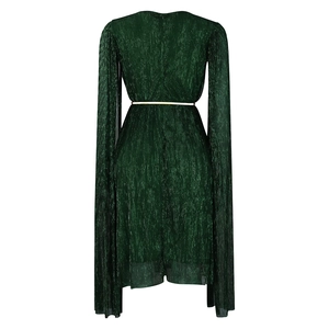Detail of dark green pleated gown with cape sleeves and a slim gold metal belt