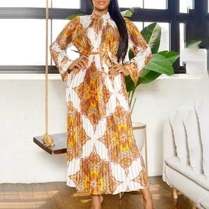 Detail of vintage paisley print and fine accordion pleats on long sleeve maxi dress