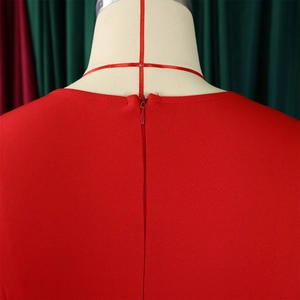 Close-up of the invisible zipper and high-quality textured fabric on a red dress back