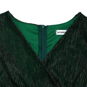 Close-up of V-neck dark green pleated dress with metallic shimmer and back zipper