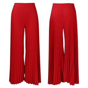 Detail of red high waisted pleated wide leg trousers with premium vertical pleats