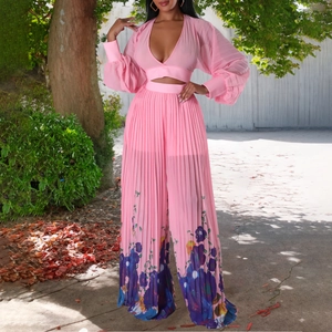 Detail of pink chiffon deep V-neck pleated top and floral print wide leg trousers