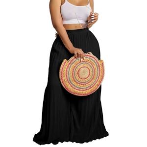 Detail view of high-waist black pleated wide-leg pants for women in summer style