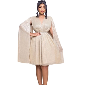 Detail of the shiny gold V-neck party dress with pleated texture and cape sleeves