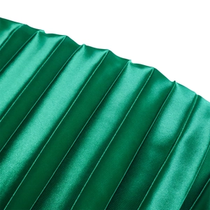 Macro detail of emerald green satin fabric with elegant pleated texture and silk luster