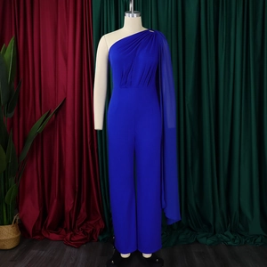 Detail of royal blue one-shoulder jumpsuit with asymmetric cape and pleated waist design