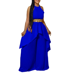 Detail of royal blue sleeveless halter top and pleated wide leg trousers with gold belt