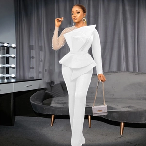 Detailed view of sheer mesh sleeve with elegant pearl beads and white ruffle waist