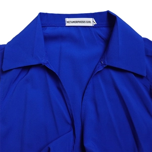 Detailed view of royal blue lapel collar with METAMORPHOSIS GIRL brand woven label