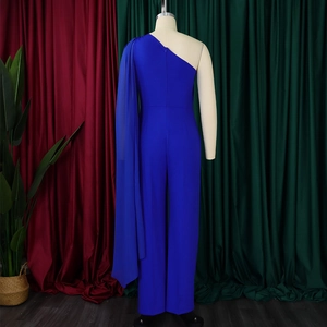 Detail of royal blue one-shoulder jumpsuit featuring an elegant long chiffon cape sleeve