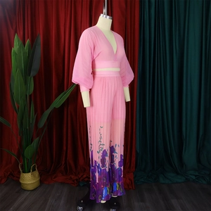 Detailed view of pink chiffon two-piece set featuring vibrant floral prints on wide-leg pants