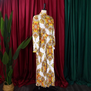 Detail of yellow paisley print on pleated long-sleeve maxi dress with waist tie