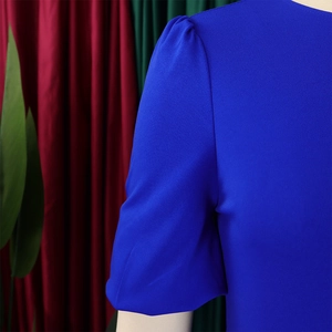 Detail of royal blue puffy sleeves and twill fabric texture on a slim fit dress