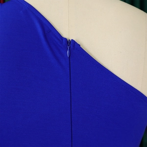 Detail of the invisible zipper and textured royal blue fabric on a one-shoulder jumpsuit