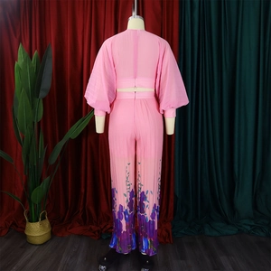 Rear view of pink two-piece set featuring lantern sleeve top and floral print wide leg pants