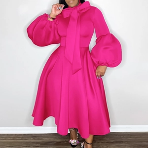 Detail of fuchsia dress with oversized bow tie and dramatic lantern sleeves