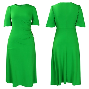 Detail of bright green slim-fit dress with puff sleeves and gold buttons at the waist