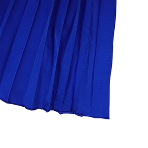 Detailed macro shot of royal blue pleated fabric texture on wide-leg fashion jumpsuit
