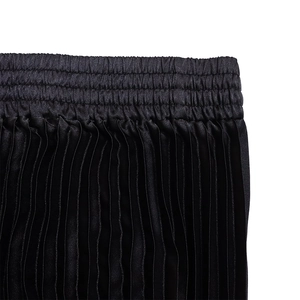 Detail of high elastic waistband and vertical pleated satin fabric in black color