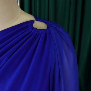 Detail of royal blue one-shoulder jumpsuit with pleated shoulder and metal ring buckle
