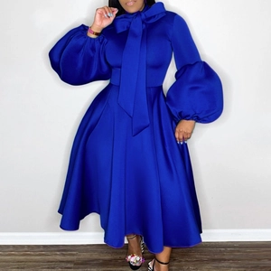 Detail view of deep blue evening gown with puff sleeves and large bow neckline