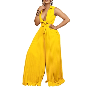 Bright yellow pleated jumpsuit with deep V-neck and wide leg silhouette in high-quality fabric