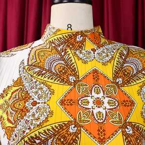 Detail of high neck design and intricate mandala print on lightweight long sleeve dress