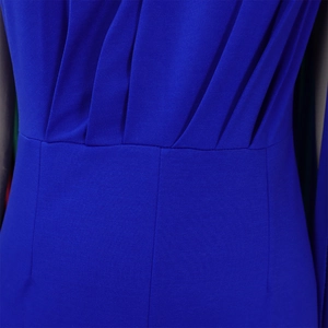Detailed macro view of royal blue jumpsuit fabric with elegant pleated texture and draped layers
