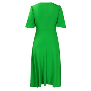 Detail view of the back showing invisible zipper on a bright green short sleeve dress