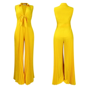 Detail of bright yellow V-neck pleated wide leg jumpsuit with a front bow tie