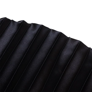 Detail of premium black satin pleated fabric with subtle glossy finish and fine texture