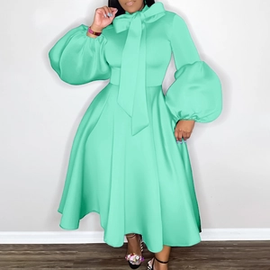 Detailed view of mint green puff sleeves and bow-tie neckline on A-line dress