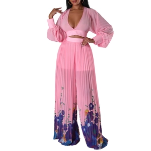 Detail of V-neck pleated crop top and wide-leg trousers with vibrant floral print