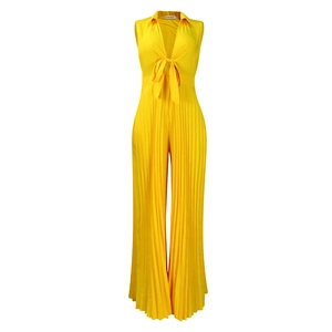 Detail showing the pleated fabric texture and V-neck tie on this yellow wide-leg jumpsuit