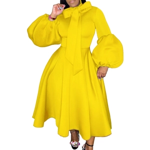 Detail of plus size yellow gown showing lantern sleeves and large decorative bow knot