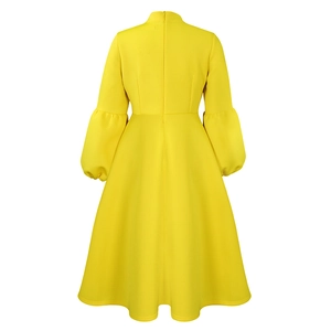 Back view detail of yellow lantern sleeve dress featuring an invisible zipper and A-line skirt