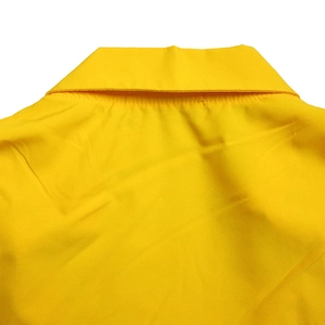 Detail of the bright yellow V-neck collar with precise stitching and smooth fabric texture
