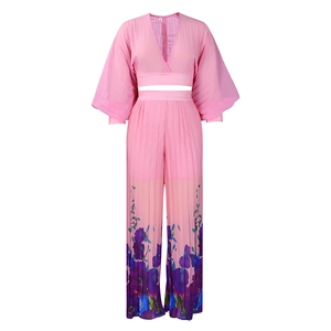 Detail of hot pink pleated chiffon set featuring wide-leg pants with floral patterns