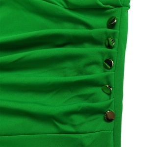 Detail of green short sleeve dress with side ruching and five gold metallic buttons