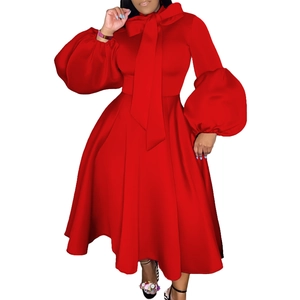 Detail of red party dress showing the elegant bow neckline and puff lantern sleeves