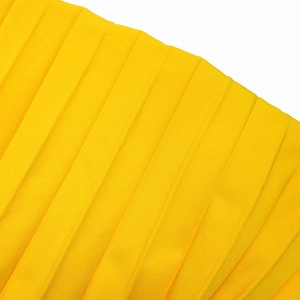 Detail shot of bright yellow pleated chiffon fabric with vertical texture and fine finish