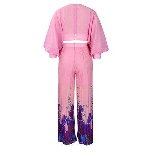 Rear view of pink chiffon long sleeve crop top and high waist floral wide leg trousers