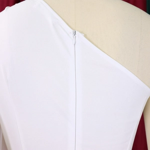 Detail shot of invisible zipper closure on white one-shoulder jumpsuit for formal events