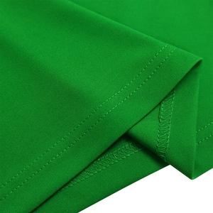 Detail view of double-needle hem stitching and overlock seams on green fabric dress