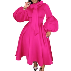 Detail of fuchsia puff sleeves and large bow tie neckline on the elegant maxi dress