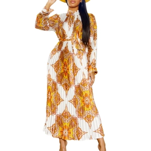 Detail of bohemian floral pleated dress with high neck and vibrant orange ethnic print
